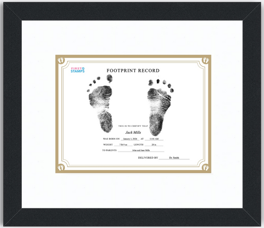 Framed baby footprint record with black and white footprints on a white background