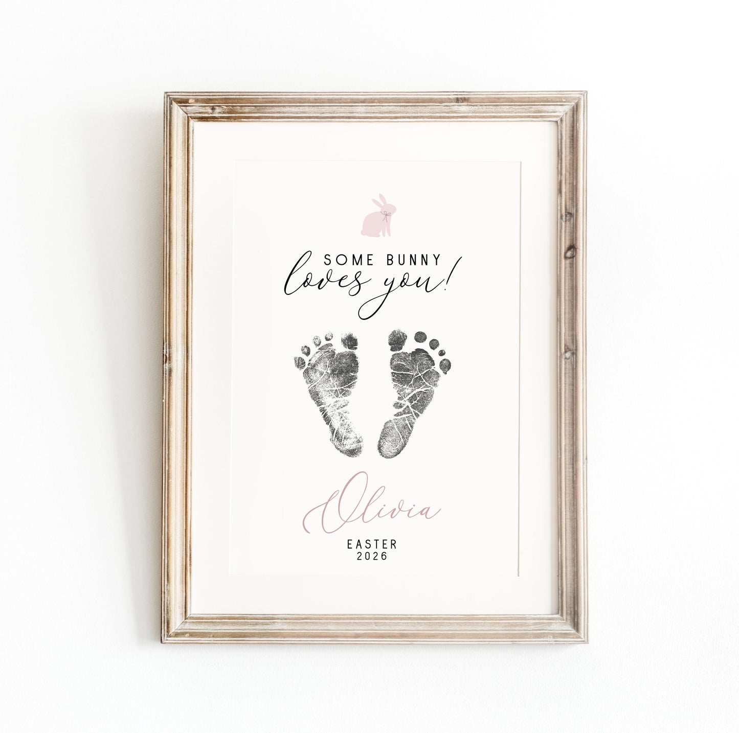 Framed keepsake with baby footprints and text 'Some bunny loves you! Olivia Easter 2020' on a white background
