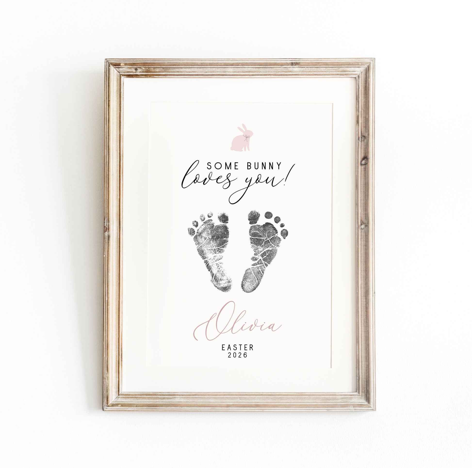 Framed keepsake with baby footprints and text 'Some bunny loves you! Olivia Easter 2020' on a white background