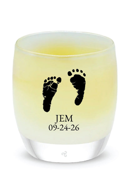 Glassybaby candle with footprints and text on a white background