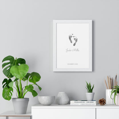 Framed keepsake print with baby footprints on a wall above a white cabinet with decorative items.