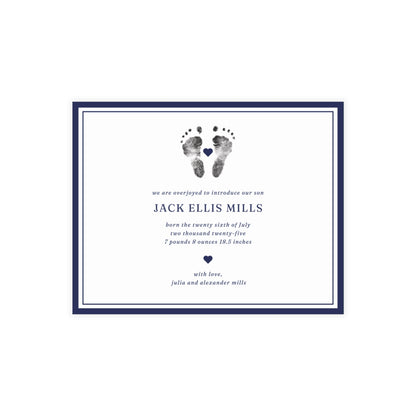 Newborn baby announcement card with footprints and text on a white background