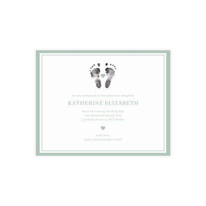 Newborn baby announcement card with footprints and text on a white background
