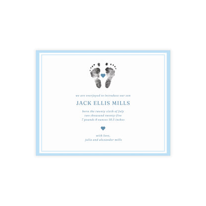 Newborn baby announcement card with footprints and text on a white background