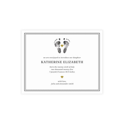 Newborn baby announcement card with footprints and text on a white background