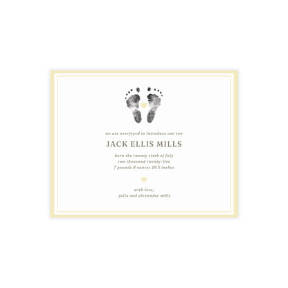 Newborn baby announcement card with footprints and text on a white background