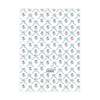 Blue patterned paper with floral and bow design on a white background. First Stamps logo at bottom.