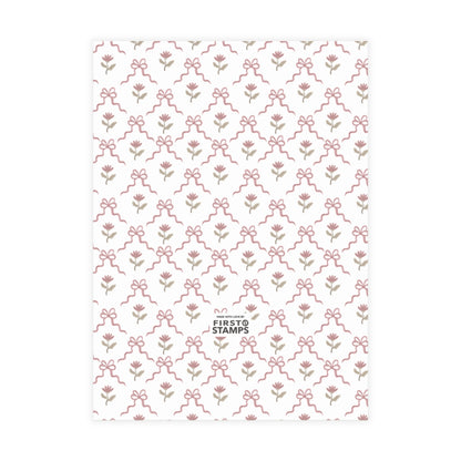Red patterned paper with floral and bow design on a white background. First Stamps logo at bottom.