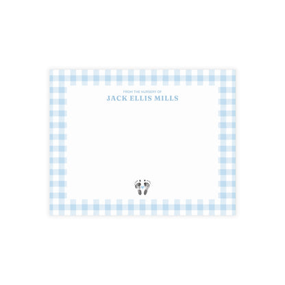 Light blue gingham border with baby footprints and text on a white card.