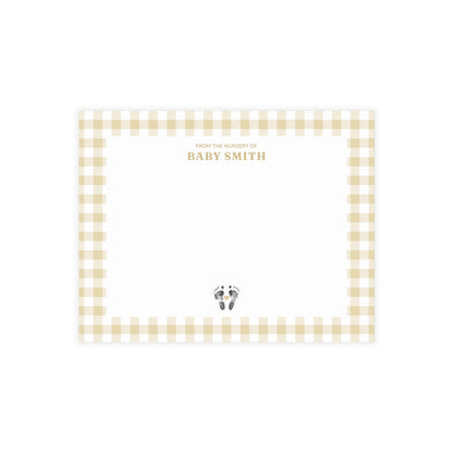 Yellow gingham border with baby footprints and text on a white card.