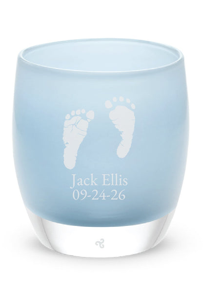 Glassybaby tea light holder with engraved baby feet and name on a white background