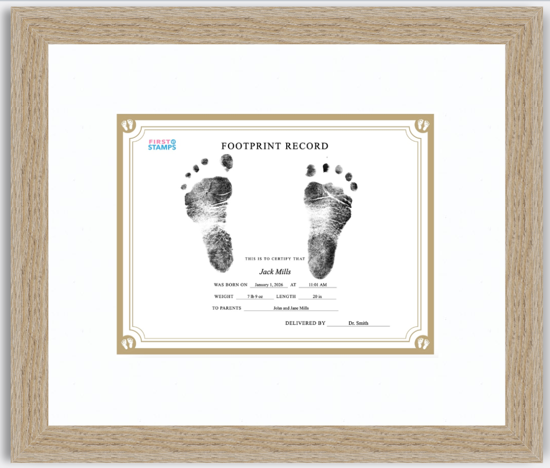 Framed baby footprint record with black and white footprints on a white background