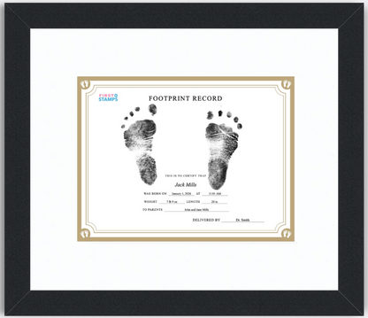 Framed baby footprint record with black and white footprints on a white background