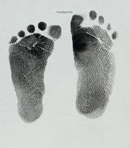 Two inked newborn footprints on paper labeled Footprints